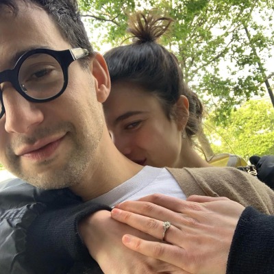 Margaret Qualley showing her engagement ring as she hugs Jack Antonoff.